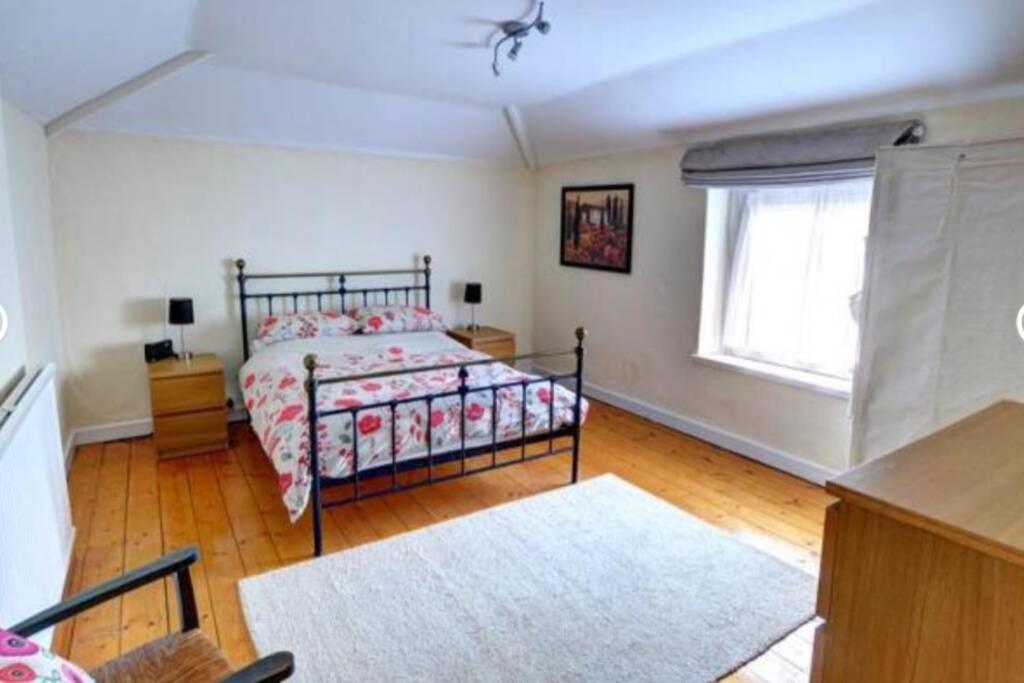 a bedroom with a bed and a window at Taffs Well Cottage in Taffs Well
