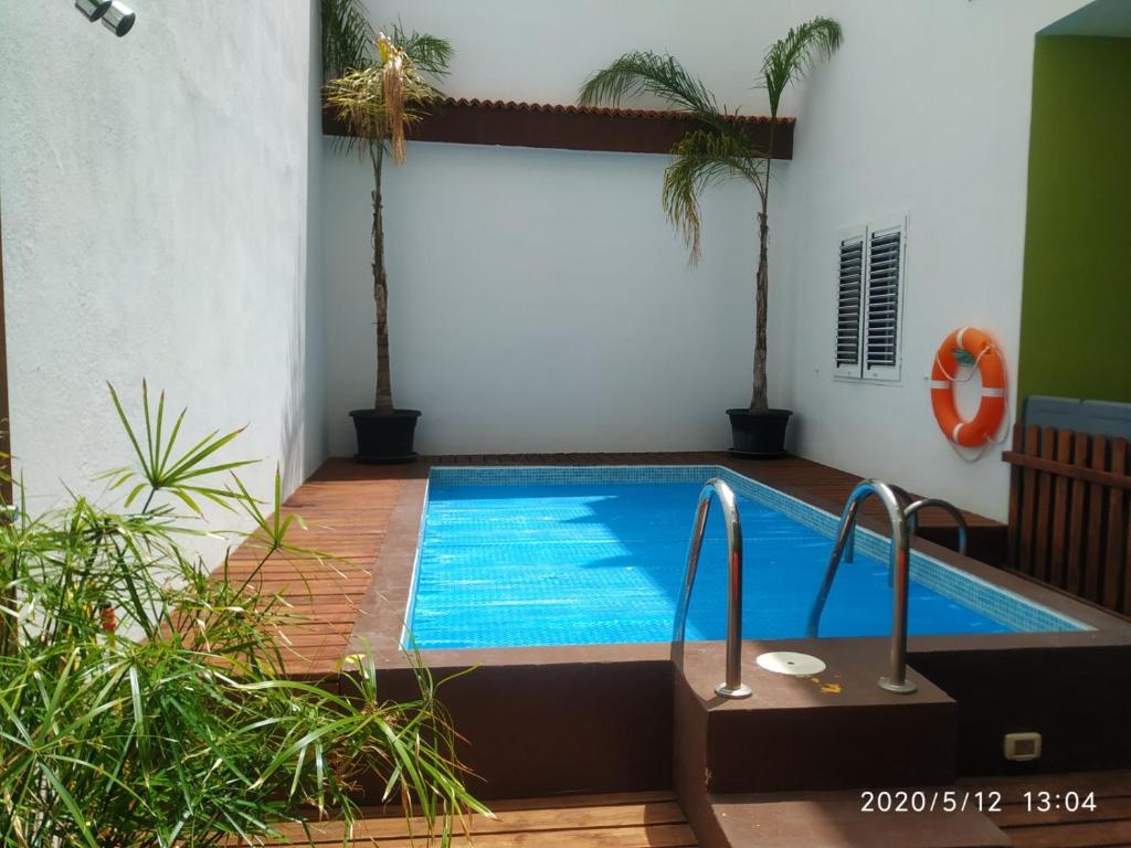 a swimming pool in the middle of a house at Apartamentos El Patio in Los Llanos de Aridane