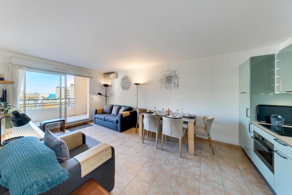 a living room with a kitchen and a dining room at Sea Spray 2 bed, Monaco view, beach apartment in Beausoleil
