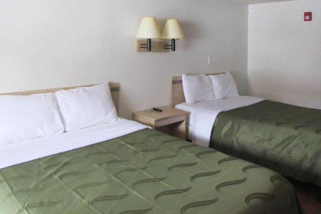 a hotel room with two beds and a table at Rodeway Inn in Washington