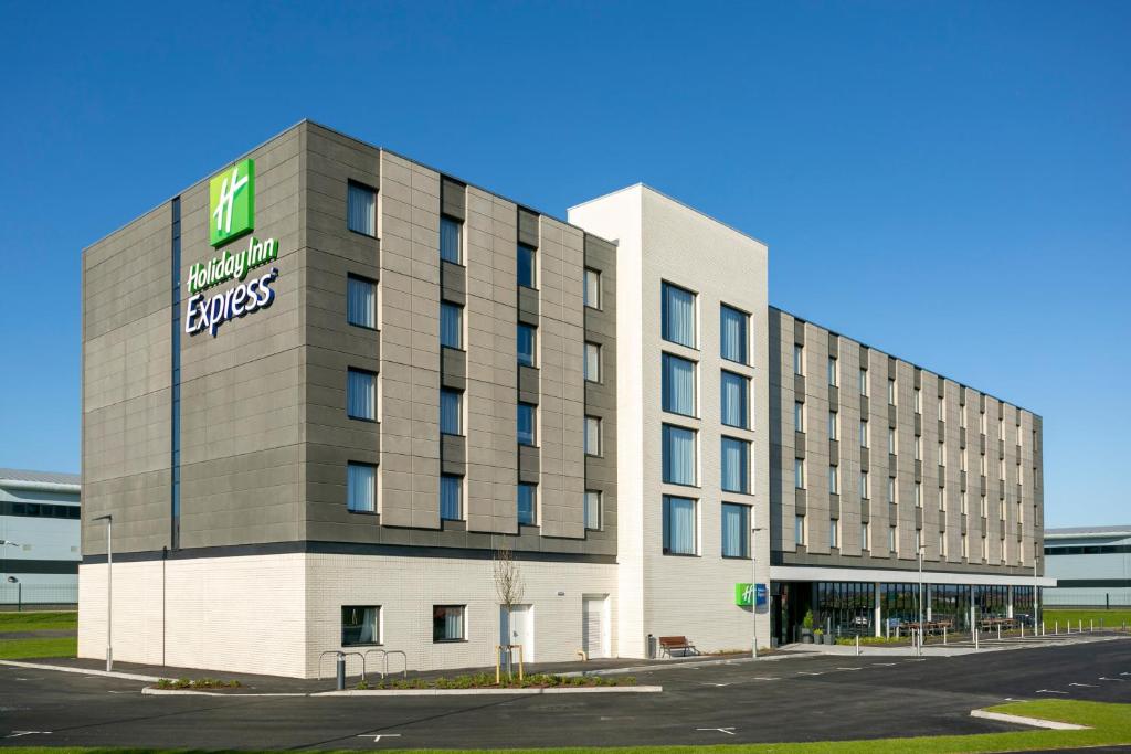 a large building with a large clock on the side of it at Holiday Inn Express Bridgwater M5, Jct24, an IHG Hotel in Bridgwater