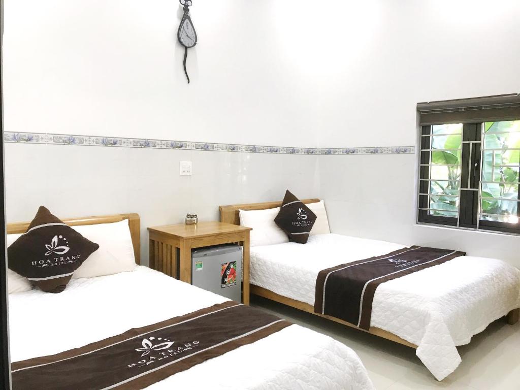 a room with two beds and a window at Hoa Trang Hotel in Tuy An