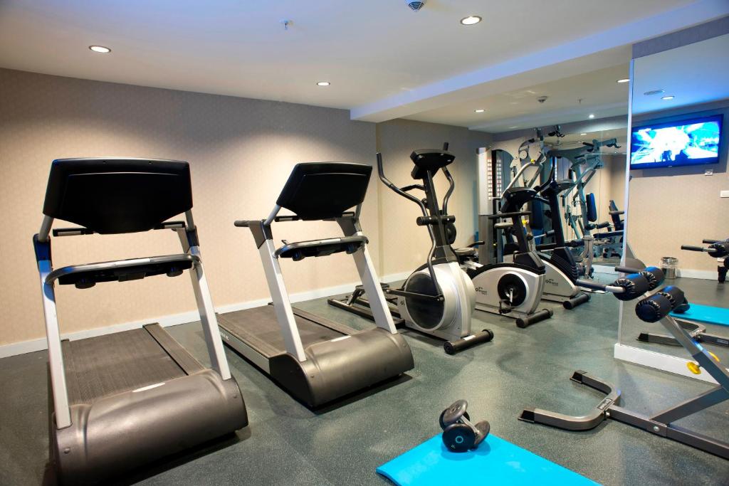 a gym with several exercise bikes and a television at Nidya Hotel Galataport in Istanbul