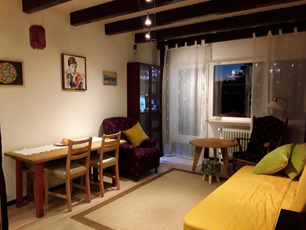 a living room with a bed and a table and chairs at Ferienwohnung im Naturpark Solling Vogler in Silberborn