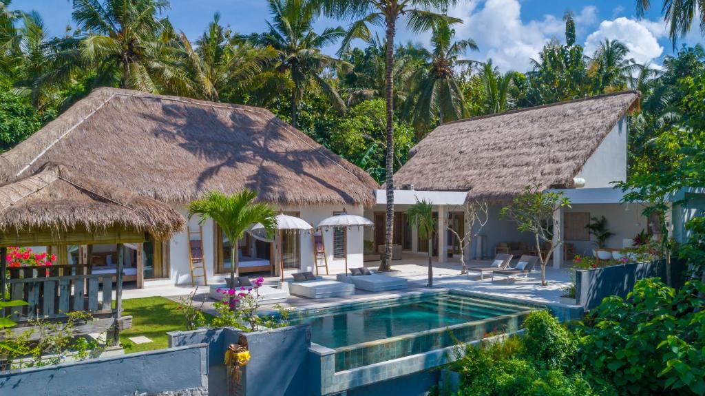 a villa with a swimming pool and a resort at Villa Hidden Jewel, including private cook and butler service in Jasri