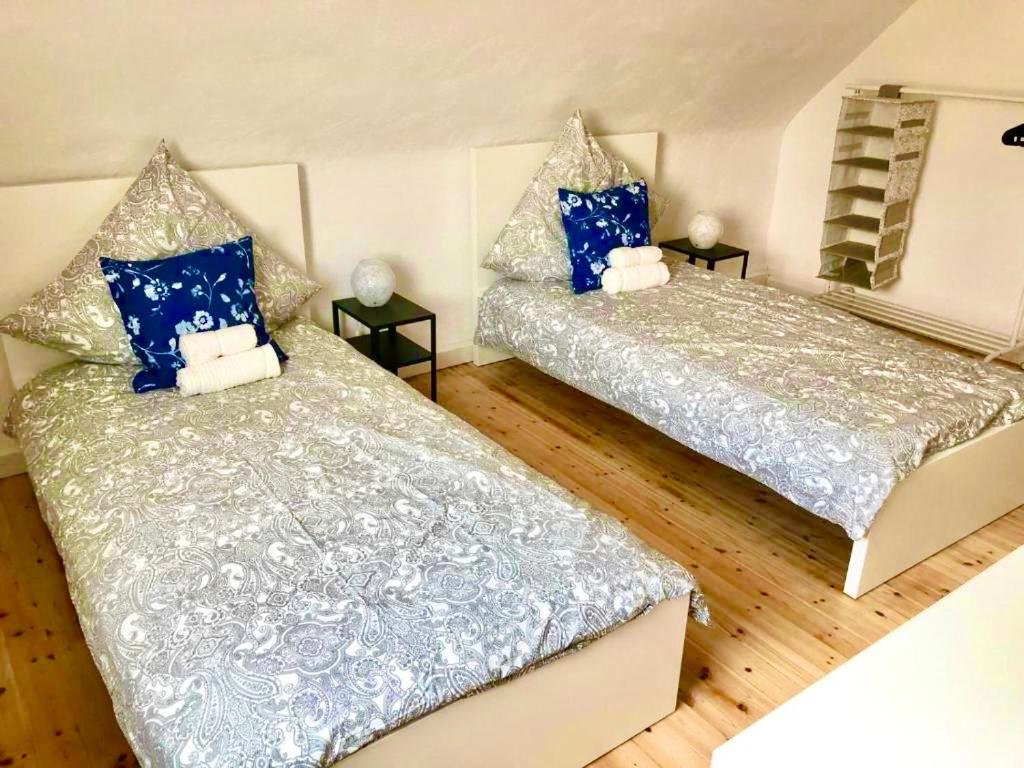 two beds in a room with blue and white at Modern CITY Apartments in Kaiserslautern
