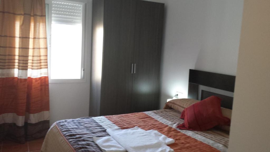 Łóżko lub łóżka w pokoju w obiekcie Pension Gran Plaza