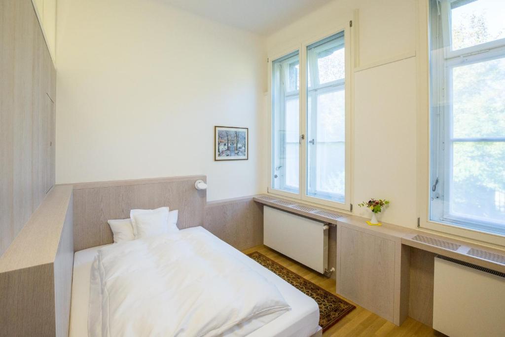 Postel nebo postele na pokoji v ubytování Gästehaus der Katholischen Akademie in Bayern