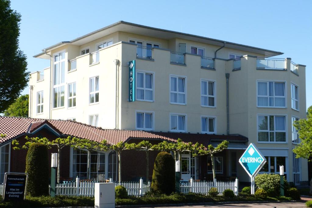 a large white building with a sign in front of it at Hotel Evering in Emsbüren