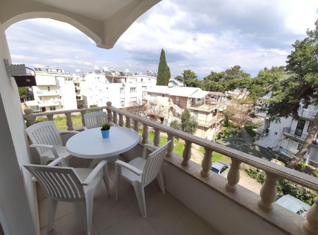 a balcony with a table and chairs and a view at Karina Butik Apart in Didim
