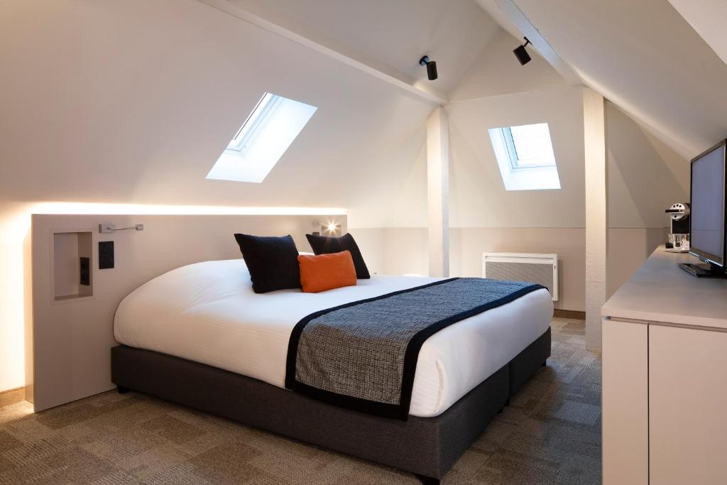 Postel nebo postele na pokoji v ubytování Hôtel Gutenberg