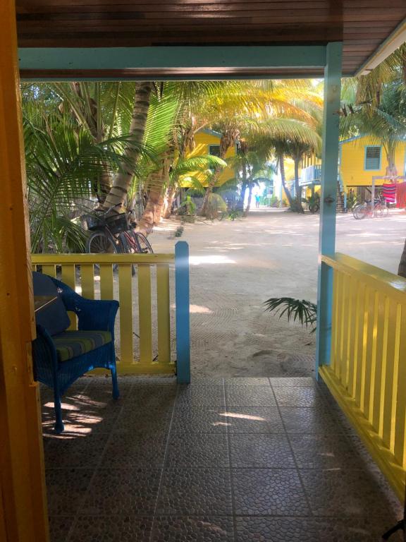 an open door to a porch with a bench at Colinda Cabanas in Caye Caulker