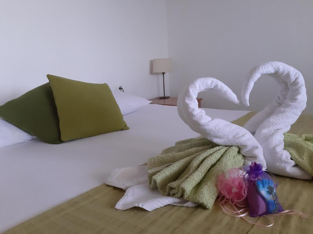 two towel swans are sitting on a bed at Villa Kovačević in Trogir
