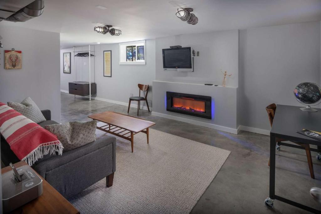 a living room with a couch and a fireplace at Southeast Portland Retreat in Portland