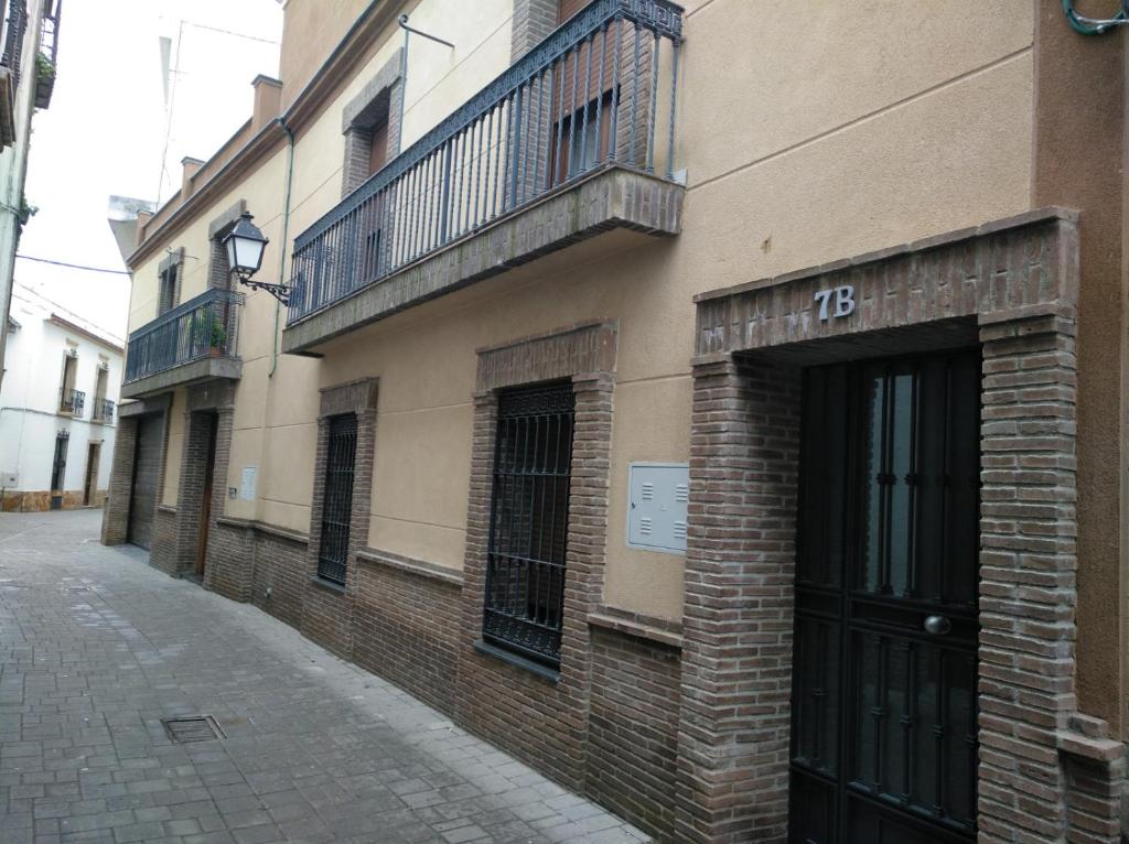 - un bâtiment en briques avec un balcon sur le côté dans l'établissement El LEGADO, à Andújar