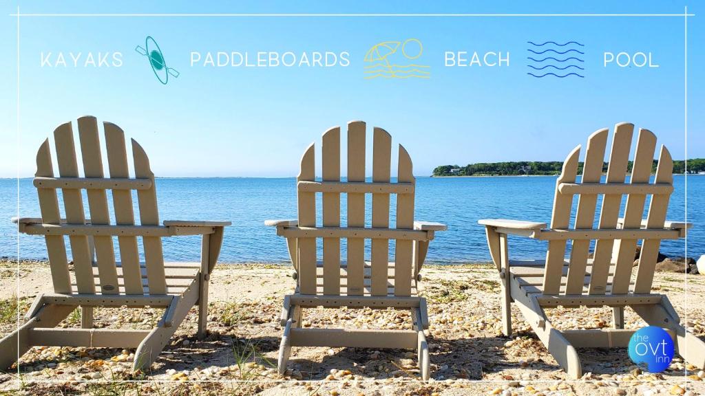 two beach chairs sitting on the sand on the beach at Ocean View Terrace in Hampton Bays