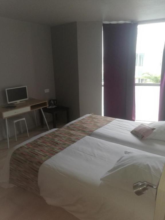 Postel nebo postele na pokoji v ubytování Hotel La Clé