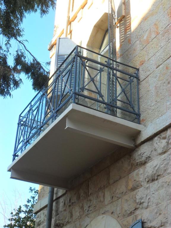 a balcony on the side of a building at Villa Brown Moshava - a member of Brown Hotels in Jerusalem