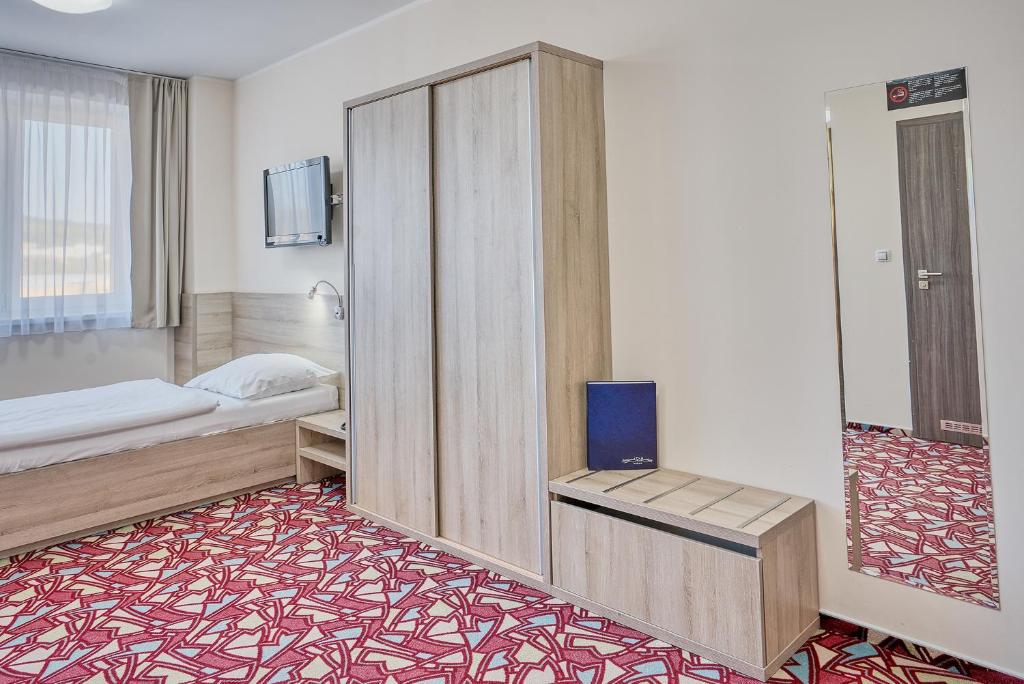 Postel nebo postele na pokoji v ubytování Hotel Arena