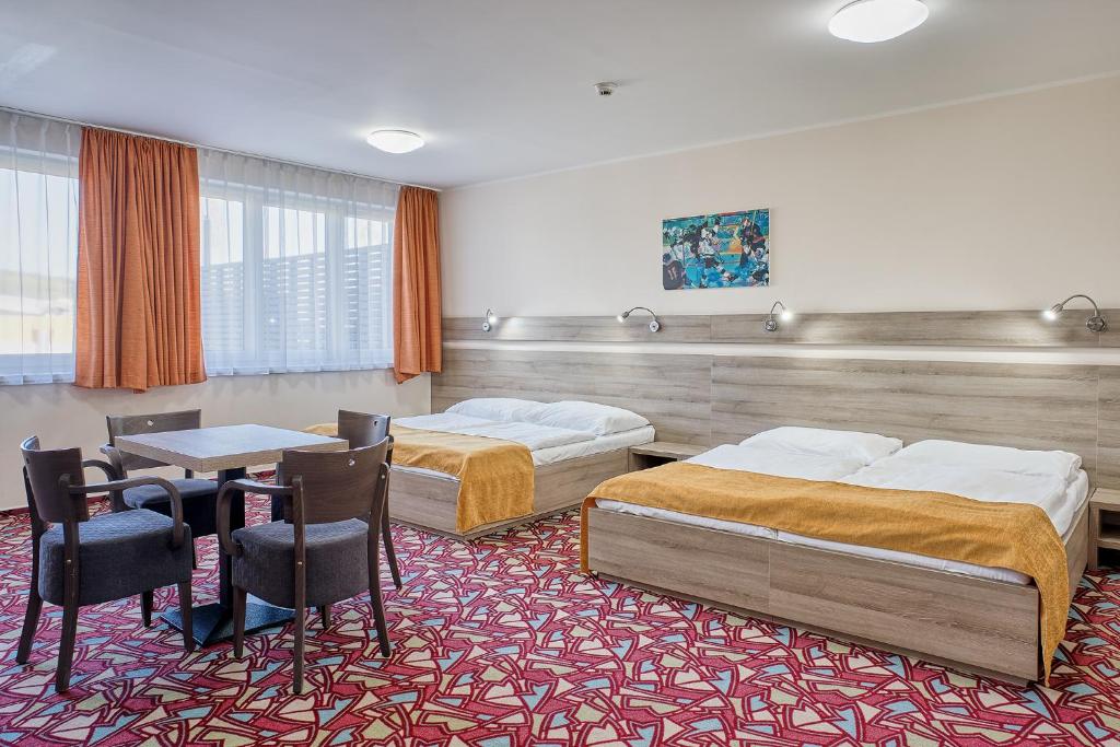 Postel nebo postele na pokoji v ubytování Hotel Arena