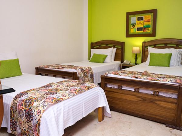 Ein Bett oder Betten in einem Zimmer der Unterkunft Hotel Castellana Real Cali