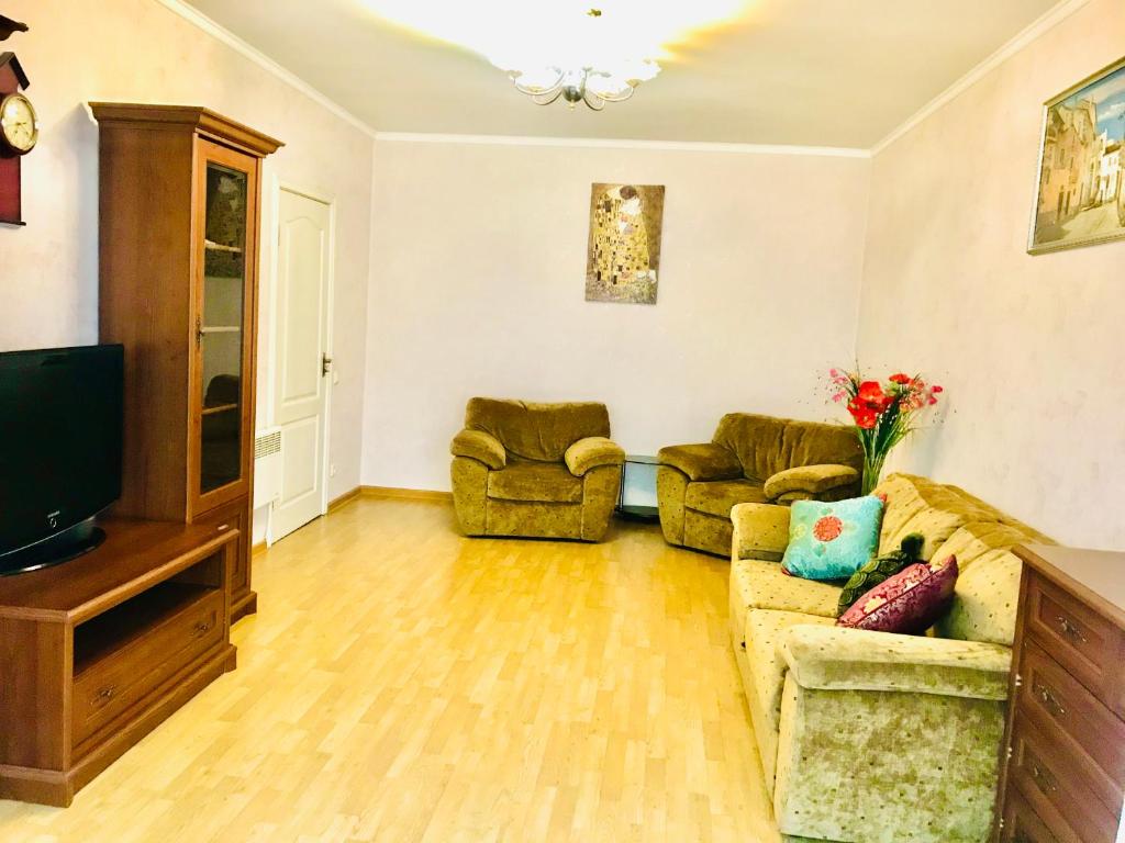 a living room with two couches and a television at Comfortable apartments,metro Kharkivska,Poznyaki in Kyiv