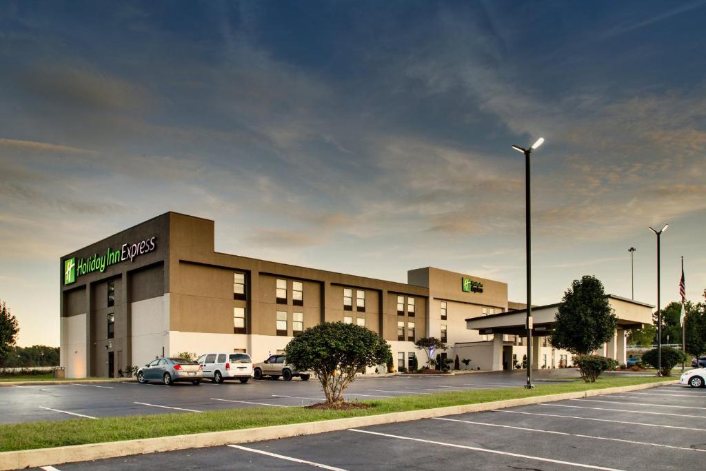 a large building with cars parked in a parking lot at Holiday Inn Express - Horse Cave, an IHG Hotel in Horse Cave