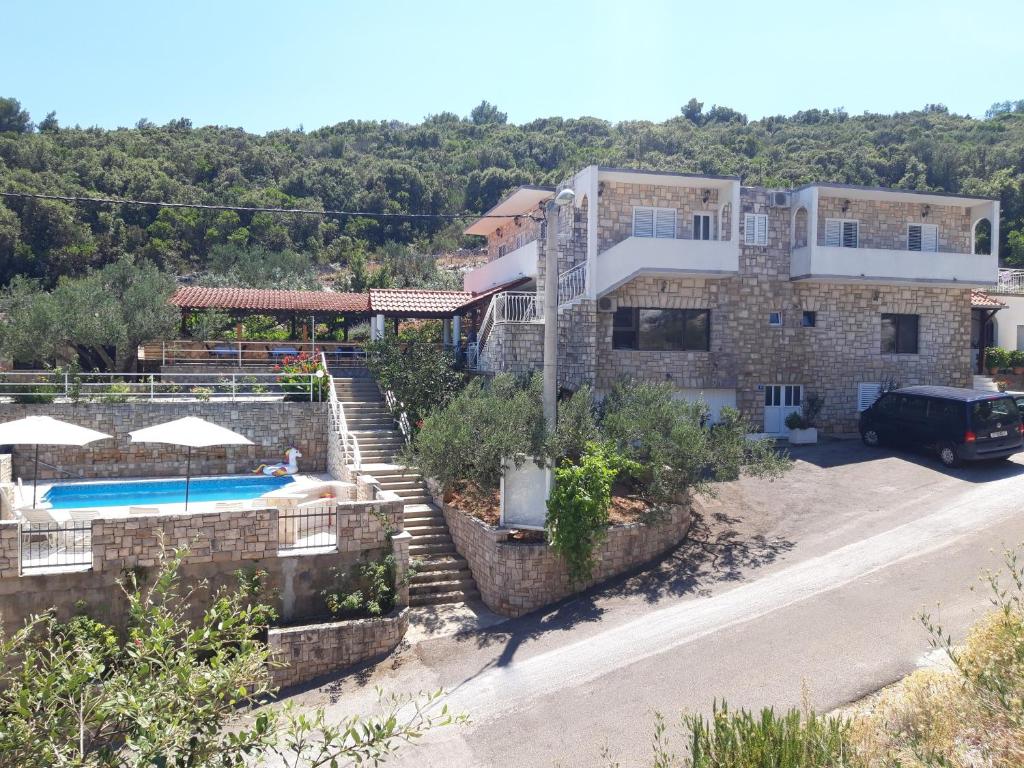 a villa with a swimming pool and a house at Villa Šolta in Rogač