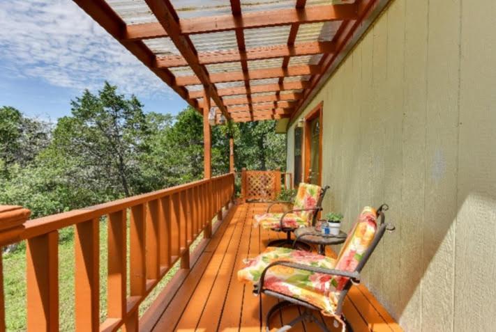 a porch with two chairs and a table on it at Austin Escape in Cedar Creek