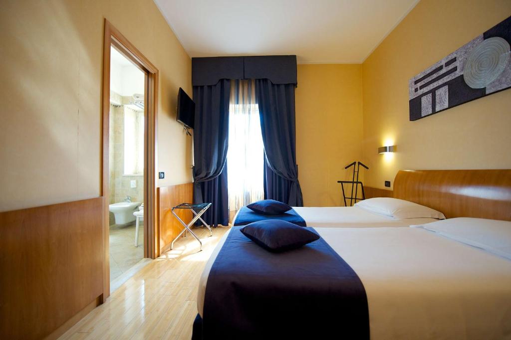 Postel nebo postele na pokoji v ubytování Best Western Hotel Luxor