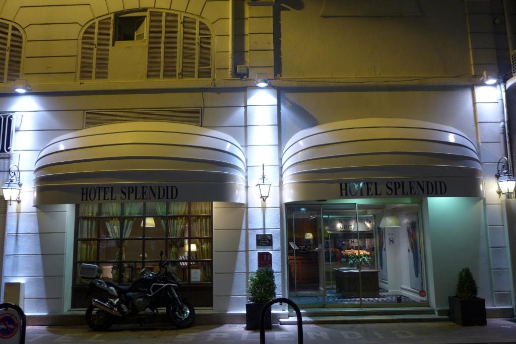a motorcycle parked outside of a building at night at Hotel Splendid in Cannes