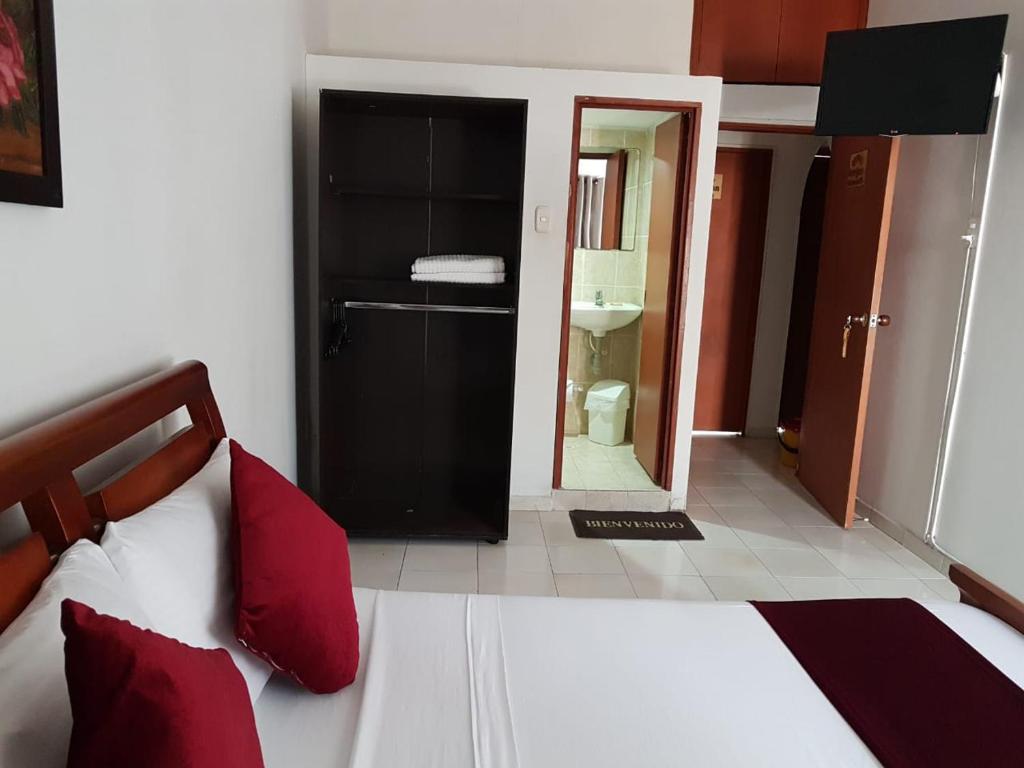 Postel nebo postele na pokoji v ubytování Hotel Don Juan Colonial