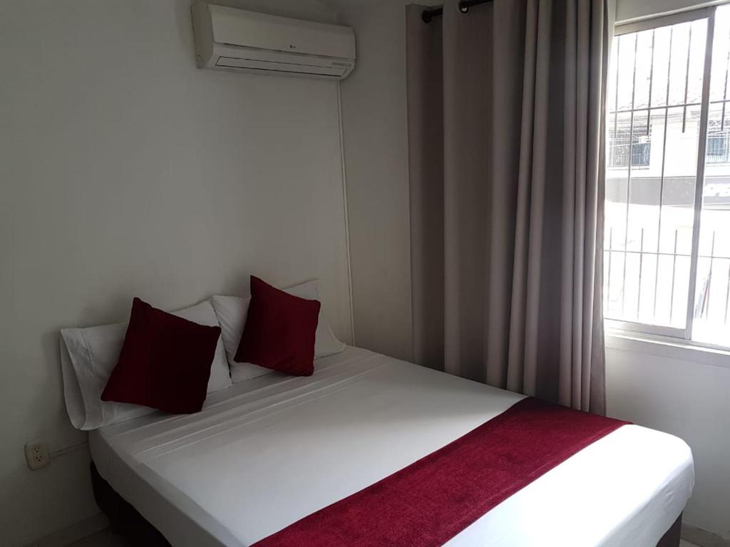 Postel nebo postele na pokoji v ubytování Hotel Don Juan Colonial
