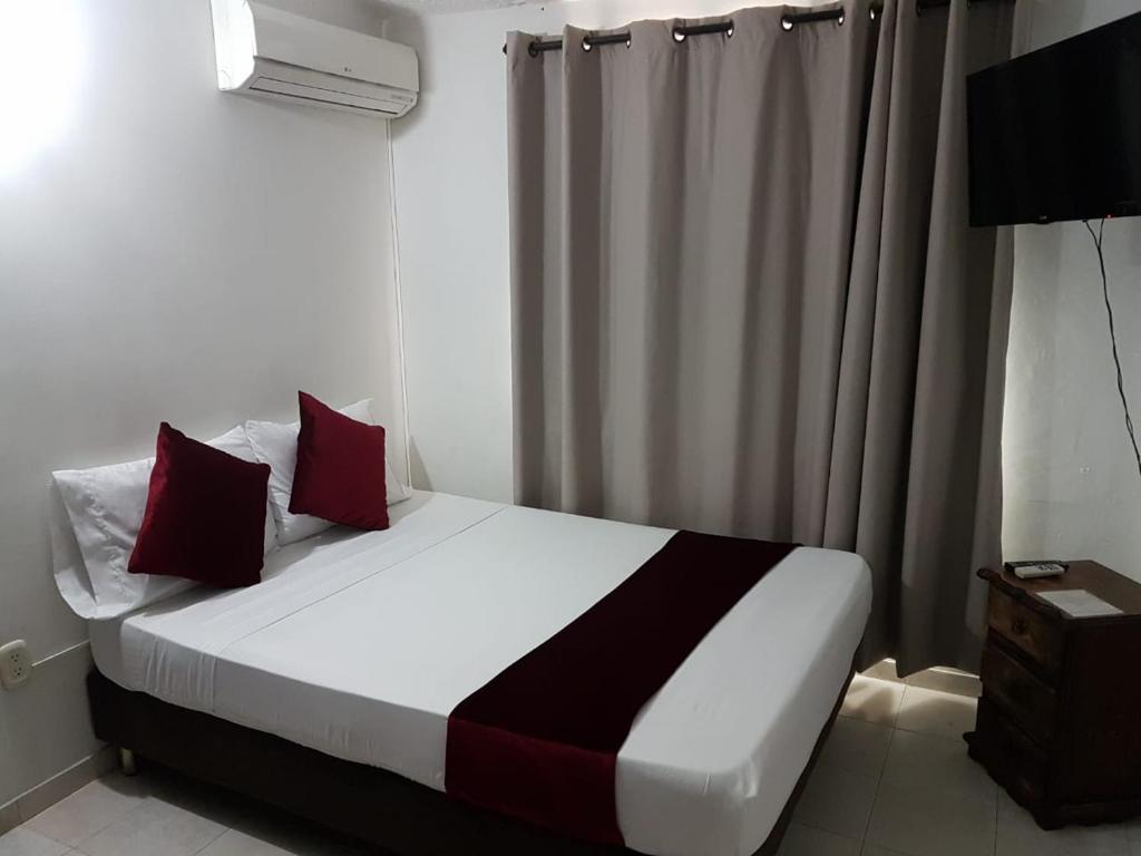 Postel nebo postele na pokoji v ubytování Hotel Don Juan Colonial