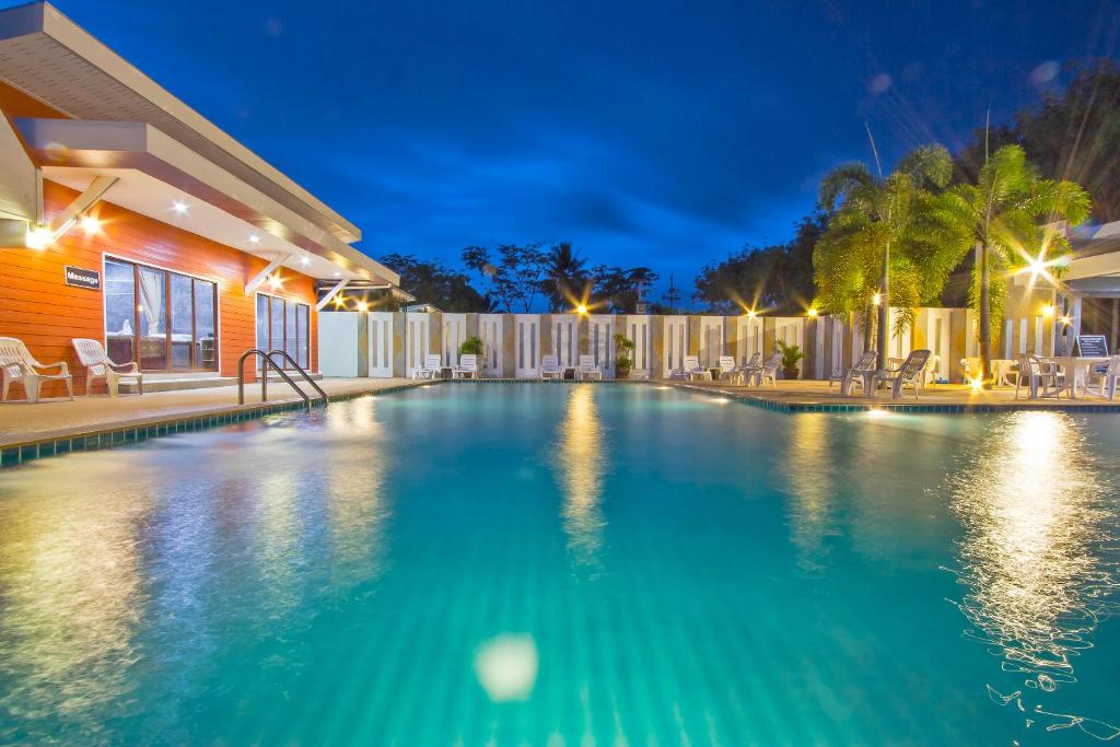a swimming pool in a house at night at Maikhao Home Garden Bungalow in Mai Khao Beach