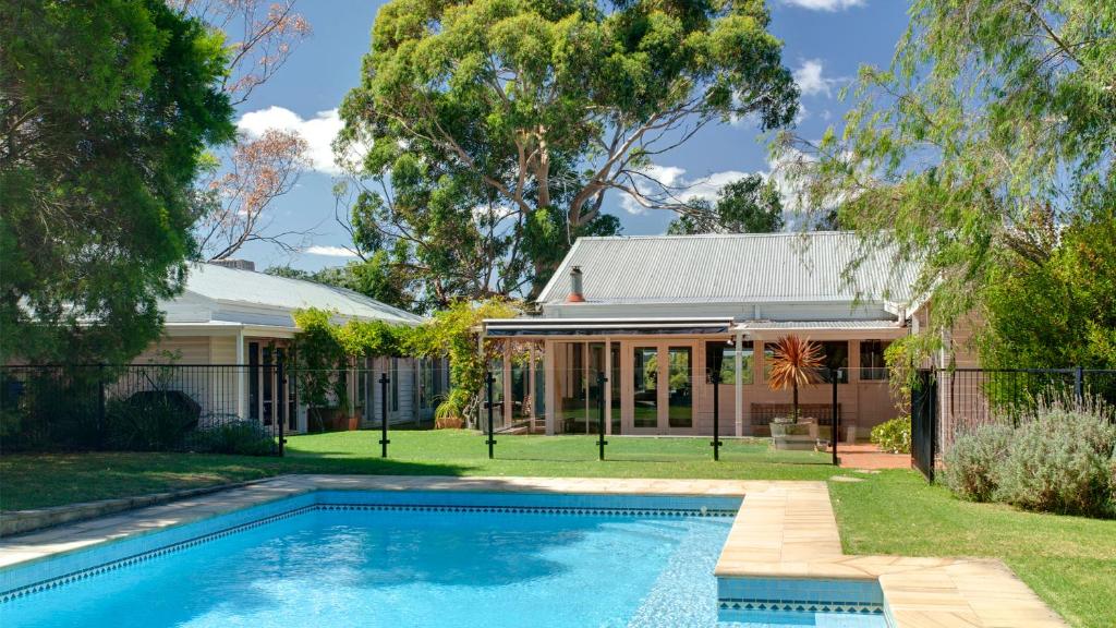 a house with a swimming pool in front of it at Merricks North Retreat in Merricks North