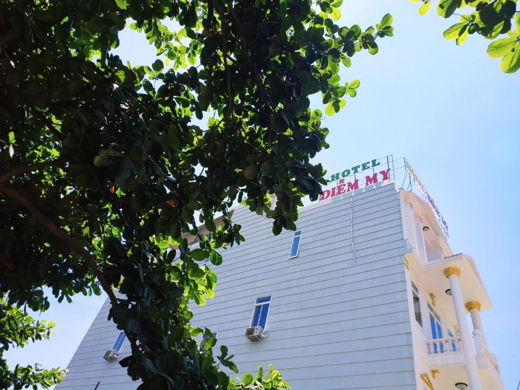 a white building with a sign on top of it at Hotel Diễm My in Quy Nhon