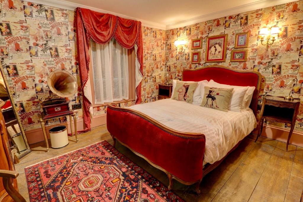 a bedroom with a bed in a room with wallpaper at Ebenezer's Place in Broadstairs