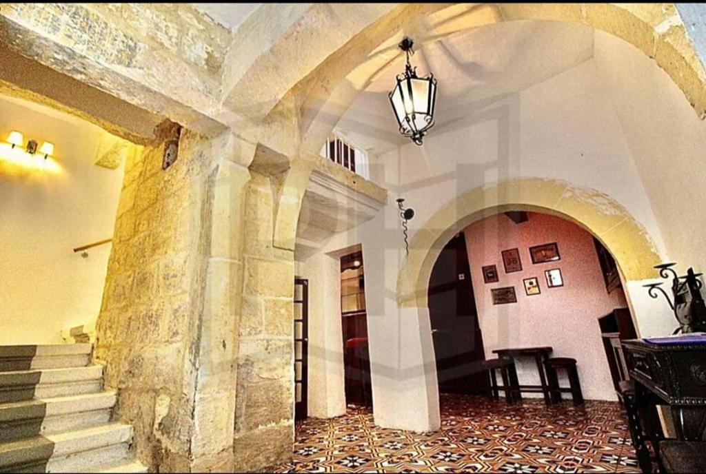 a hallway with stairs and a building with a chandelier at 16 Agius de Soldanis in Victoria