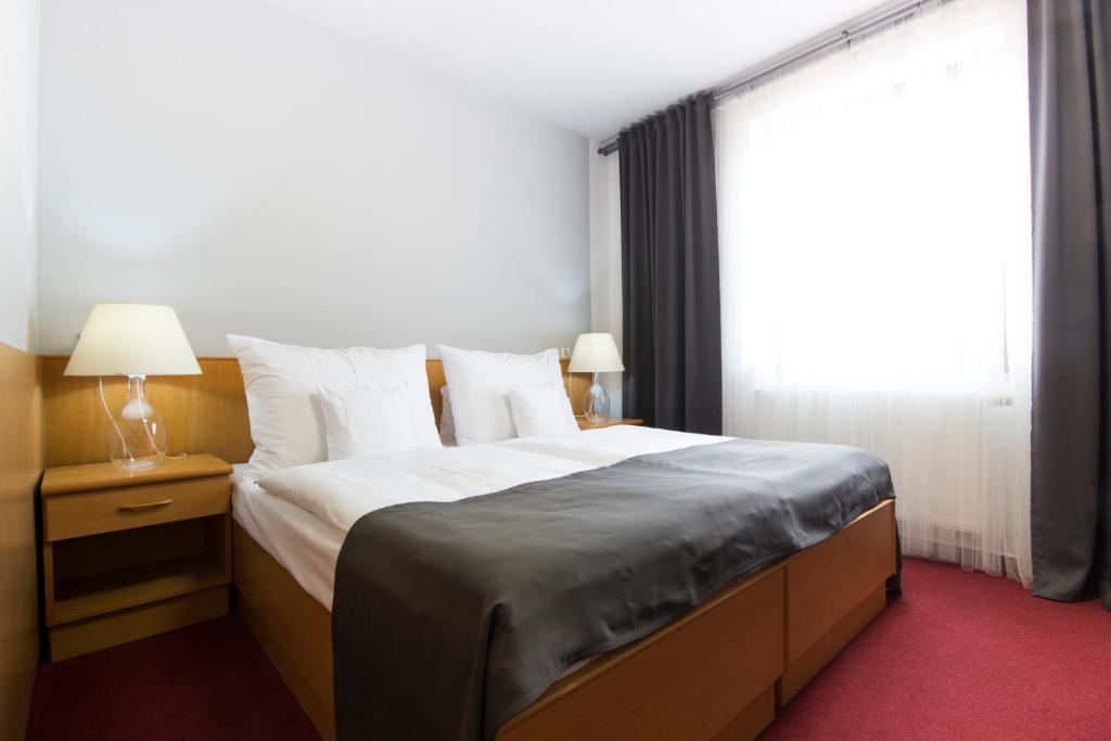 Postel nebo postele na pokoji v ubytování Hotel Maroli Mikulov