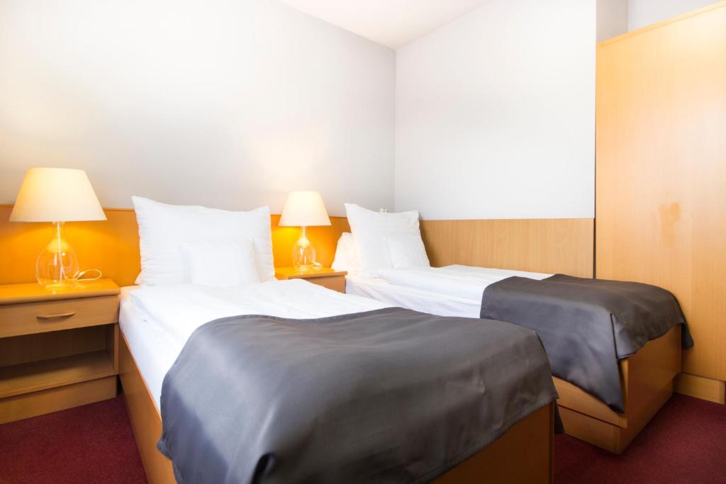 Postel nebo postele na pokoji v ubytování Hotel Maroli Mikulov