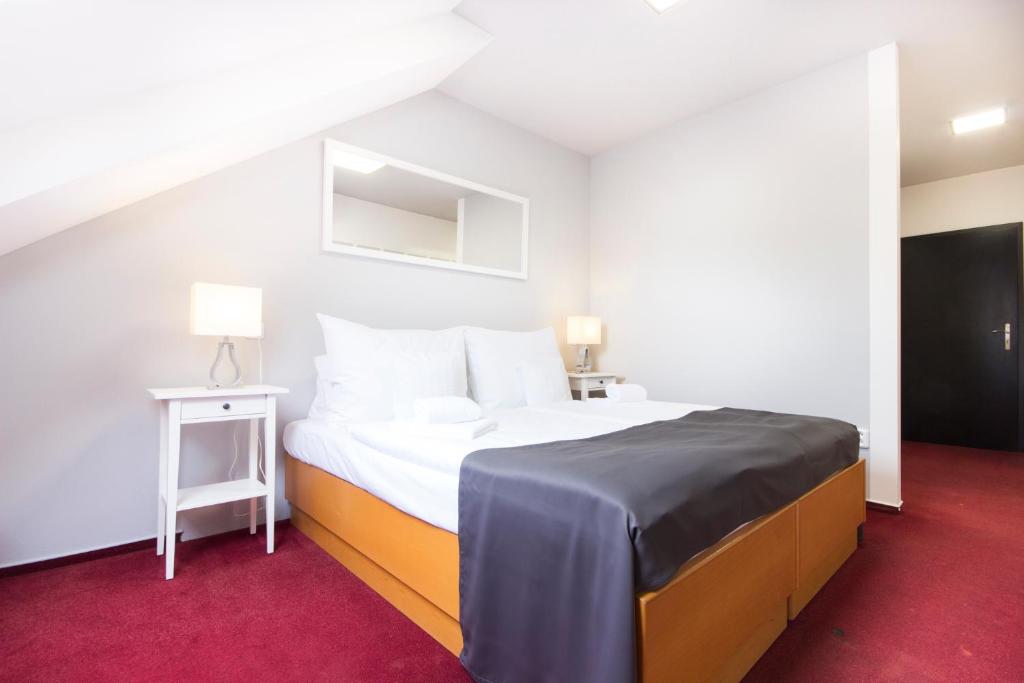 Postel nebo postele na pokoji v ubytování Hotel Maroli Mikulov