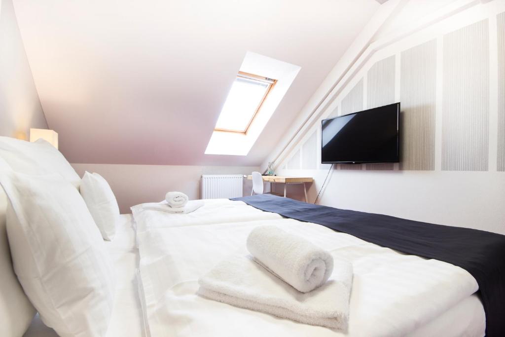 Postel nebo postele na pokoji v ubytování Hotel Maroli Mikulov