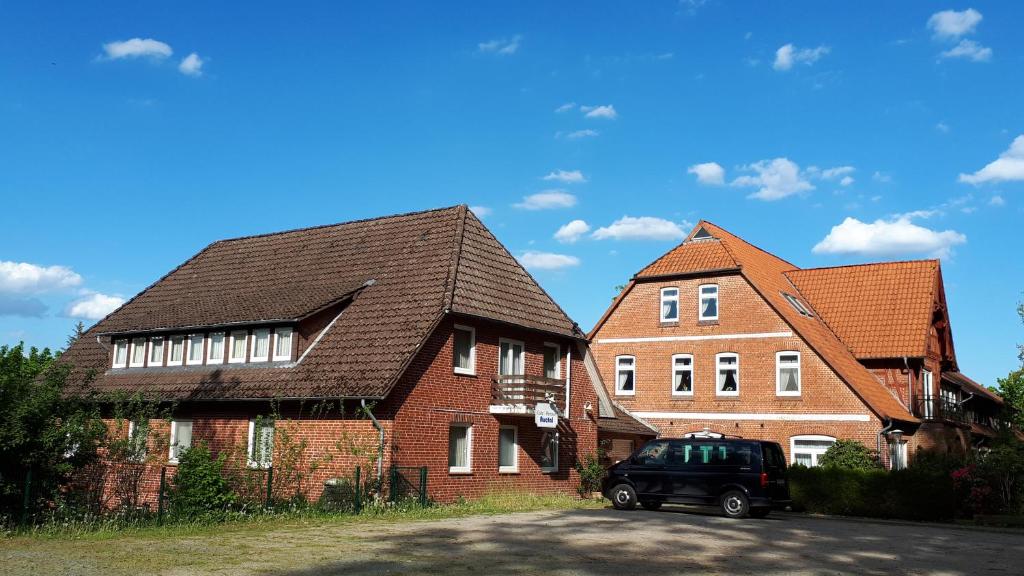 two brick houses with a car parked in front of them at Pension Auetal in Döhle