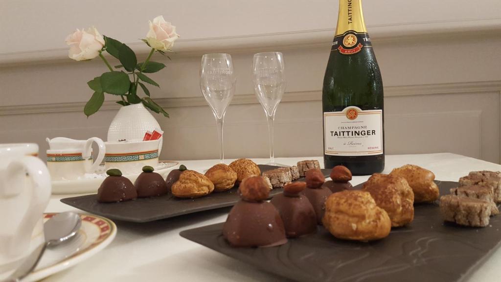 a table with a bottle of wine and chocolate desserts at Hotel Re'ser Stuff in Roeser
