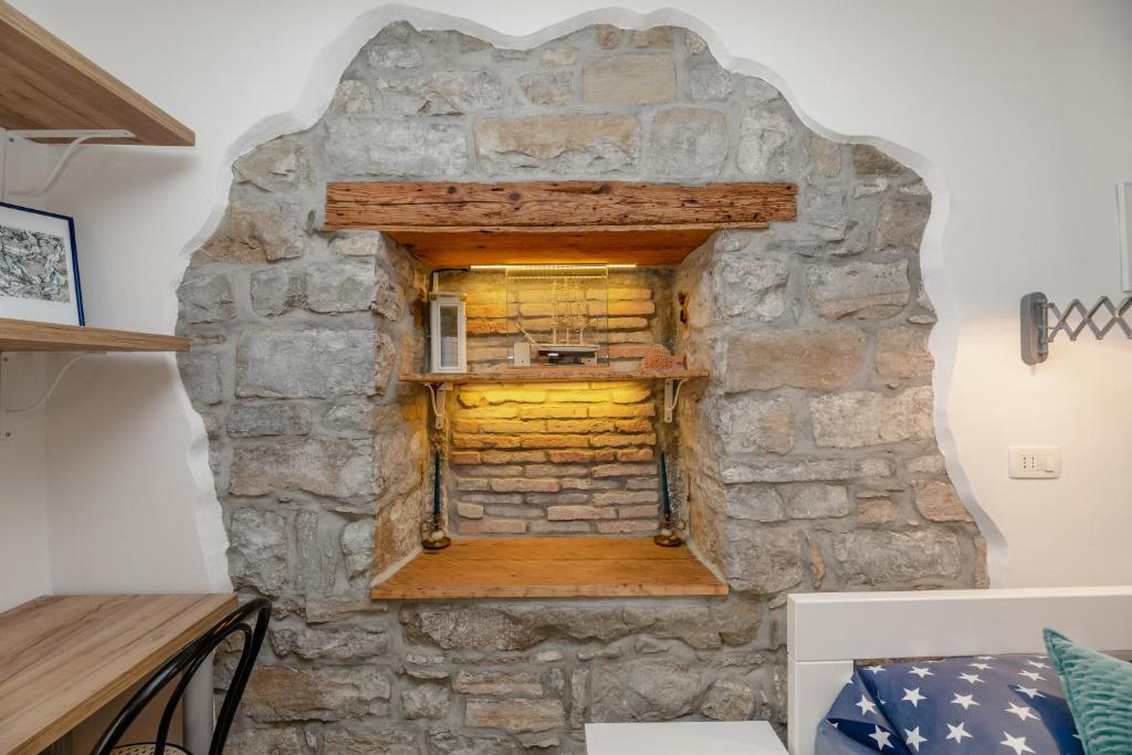 a stone wall with a window in a room at Nono Mario - Marin in Piran