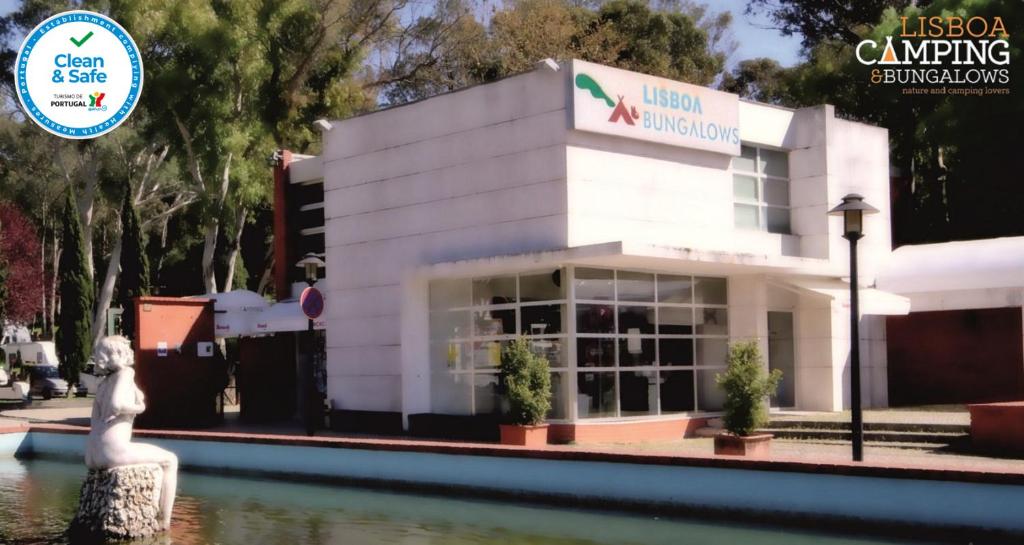 a building next to a body of water at Lisboa Bungalows in Lisbon