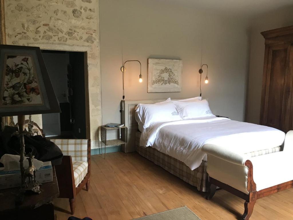 a bedroom with two beds and a television in it at Château Sigalas Rabaud in Bommes