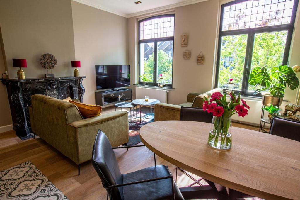 a living room with a table and chairs at Suite 105 in Maastricht