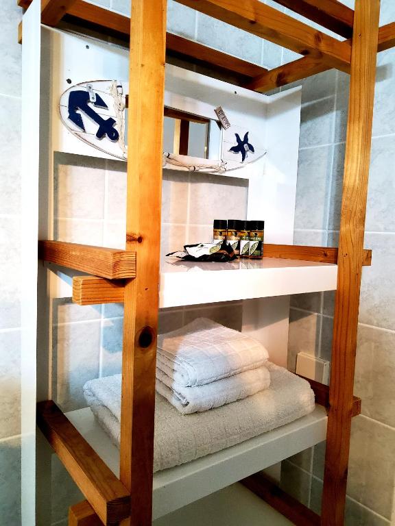 a glass shelf with towels in a room at Nefeli in Livadi